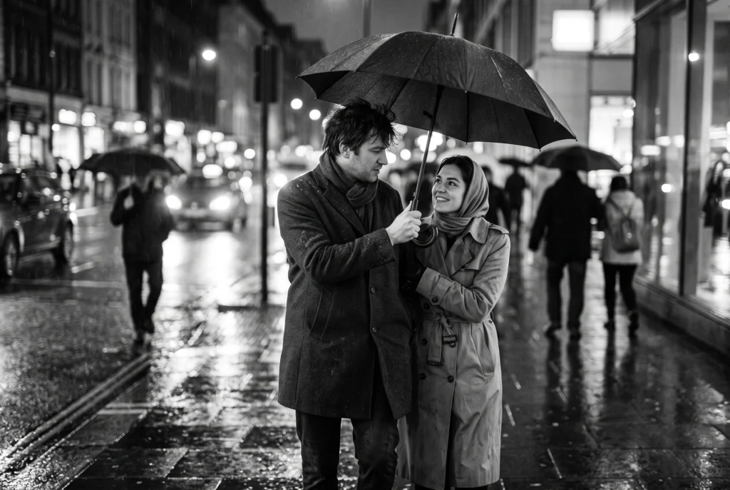 A rainy evening street: a man holds an umbrella over a smiling woman